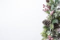 Christmas decoration, styled fir branches, pine cones, garland on white background. Top view with copy space