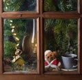 Christmas decoration with teddy bear in window Royalty Free Stock Photo