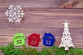 Christmas decoration with thuja branches, snowflakes, houses and fir tree on wooden background Royalty Free Stock Photo