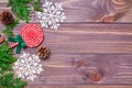 Christmas decoration with thuja branches, snowflakes, pine cones and candy on wooden background Royalty Free Stock Photo