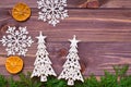 Christmas decoration with thuja branches, snowflakes, tangerines and fir tree on wooden background Royalty Free Stock Photo