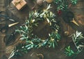 Christmas decoration toys and festive wreath over wooden background