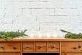 Christmas decoration with twigs on an old shelf on the background of a brick wall