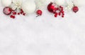 Christmas decoration. Twigs christmas red berries, apple, red and white balls, white openwork flowers on snow with space for text