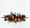 Christmas decoration. Twigs christmas tree, christmas balls, cones spruce and red berries on snow with space for text. Top view, Royalty Free Stock Photo