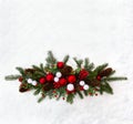 Christmas decoration. Twigs christmas tree, christmas balls, cones spruce and red berries on snow with space for text. Top view,