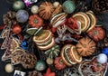 Christmas decoration. Twigs christmas tree, brown natural pine cones and and Xmas deer with variety of fruits on dark background.