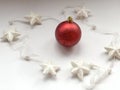 Christmas decoration on white background. Christmas tree toy, red balls, and white stars. Christmas conceptred christmas ball surr Royalty Free Stock Photo