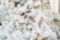 Christmas decoration, white Christmas tree with gold ornaments, leaf, garland and shiny balls. Christmas background Royalty Free Stock Photo