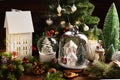 Christmas decoration with white house shaped decors under the glass cloche  and lantern on the table Royalty Free Stock Photo