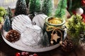 Christmas decoration with white ornaments and candle in green glass jar on round tray Royalty Free Stock Photo