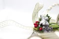Christmas decoration with white ribbon and gold details. Silver angel