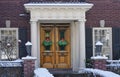 Christmas decoration on wood grain double front door Royalty Free Stock Photo