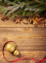 Christmas decoration, wooden background: ornaments, spices, christmas ball and ribbon