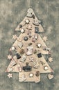 Christmas decoration: wooden carved tree decorated with gingerbread. Shabby chic style in pastel colors. Royalty Free Stock Photo