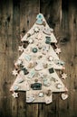 Christmas decoration: wooden carved tree decorated with gingerbread. Royalty Free Stock Photo