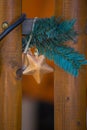 Christmas decoration on a wooden outer fence, a golden star and