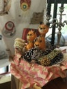 Christmas decorations in the form of foxes in a basket with pine cones