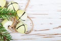 Christmas decoration-yellow jingle bells on the old white table