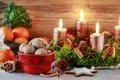 Christmas decorations: advent wreath with candles, bowl with walnuts, oranges, wooden stars Royalty Free Stock Photo