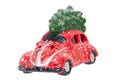 Christmas decorations background. Closeup of a snow-covered red car toy with green fir-tree on the roof isolated on a white Royalty Free Stock Photo