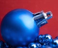 Christmas Decorations. Beautiful blue Christmas Ball on Red. Christmas Holiday Background. Royalty Free Stock Photo