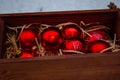 Christmas decorations in a beautiful box, red balls in the snow. Christmas decor Royalty Free Stock Photo