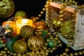Christmas decorations on a black background by candlelight. Composition of Golden balls and beads, openwork candlesticks with patt Royalty Free Stock Photo