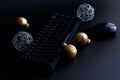 Christmas decorations, black computer keyboard and mouse on a black background. Concept of christmas and new year in IT-sphere or