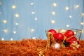 Christmas decorations on a blue background with bokeh lights garlands. The concept of an invitation. Close-up, copy space Royalty Free Stock Photo