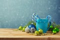 Christmas decorations with blue cup on wooden table over bokeh dreamy background Royalty Free Stock Photo