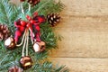 Christmas decorations - branches of coniferous trees with decorations on a wooden background