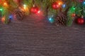 Christmas decorations with branches of fir tree, christmas lights, ball and Pine cones on wooden background. copy space Royalty Free Stock Photo