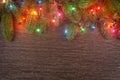 Christmas decorations with branches of fir tree, christmas lights, ball and Pine cones on wooden background. copy space Royalty Free Stock Photo