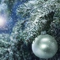 Christmas decorations in bright shimmering and shiny colors with Christmas lights with blurred snowy background. Royalty Free Stock Photo