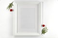 Christmas decorations in bright white colors with picture frame with white wall background. Royalty Free Stock Photo