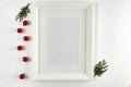 Christmas decorations in bright white colors with picture frame with white wall background. Royalty Free Stock Photo