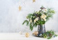 Christmas decorations, candles and flower bouquet. Winter arrangement with roses, fir branches, winter berries. Christmas flower Royalty Free Stock Photo