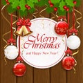 Christmas decorations with card and bauble on wooden background Royalty Free Stock Photo