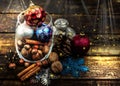Christmas decorations, cinnamon, jar with nuts.Walnuts, hazelnuts.Toned image with the effect of shooting at midnight. Royalty Free Stock Photo