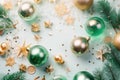 Christmas decorations concept. Top view photo of pine branches in the snow with gold-green transparent baubles star ornaments and Royalty Free Stock Photo