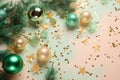 Christmas decorations concept. Top view photo of pine branches in the snow with gold-green transparent baubles star ornaments and Royalty Free Stock Photo