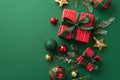 Christmas decorations concept. Top view photo of present boxes with ribbon bows red green and gold baubles star ornaments and pine Royalty Free Stock Photo