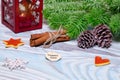 Christmas Decorations with cup of hot cocoa, lamp with candle, cinnamon sticks, pine, fir branch on wooden light blue table Royalty Free Stock Photo