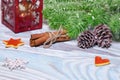 Christmas Decorations with cup of hot cocoa, lamp with candle, cinnamon sticks, pine, fir branch on wooden light blue table. Royalty Free Stock Photo