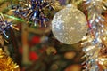 Christmas decorations decorative ball on a tree with lots of small lights and detail of decorative color chains with shallow depth