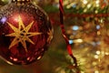 Christmas decorations decorative ball on a tree with lots of small lights and detail of decorative color chains with shallow depth