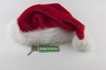 Christmas decorations: decorative house with key to the lock and Santa hat on white paper background, concept of finance and Royalty Free Stock Photo