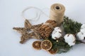 Christmas decorations eco cotton flowers, cinnamon,stars, spruce branches and jute rope hank over white background,holiday,xmas,ch Royalty Free Stock Photo