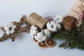 Christmas decorations eco cotton flowers, cinnamon,stars, spruce branches and jute rope hank over white background,holiday,xmas,ch Royalty Free Stock Photo